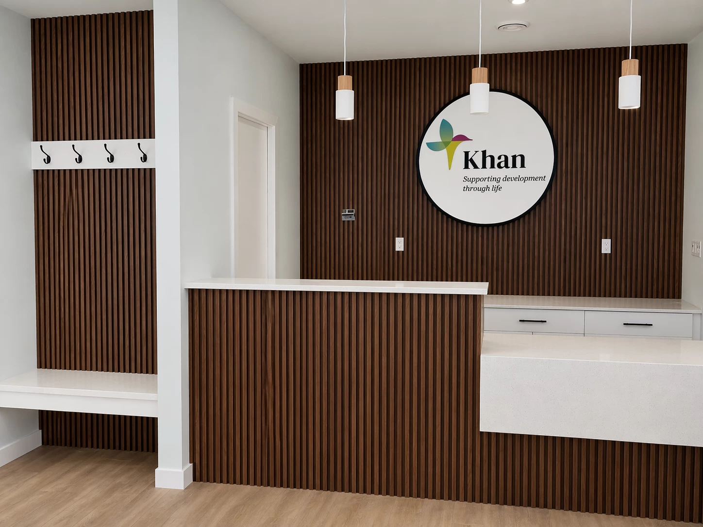 Commercial reception desk with slatted wall and signage