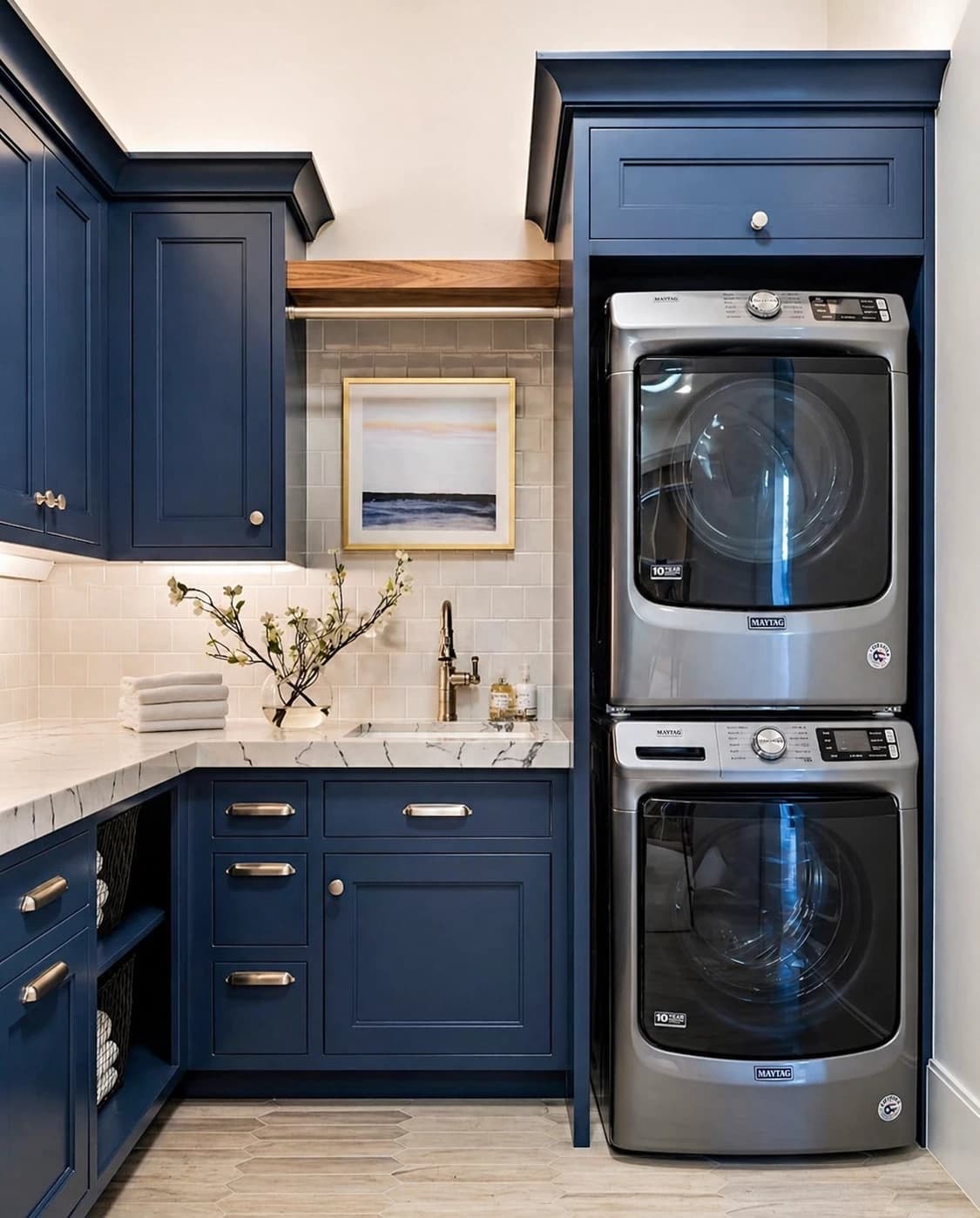 Navy blue shaker laundry room with stacked washer and dryer column