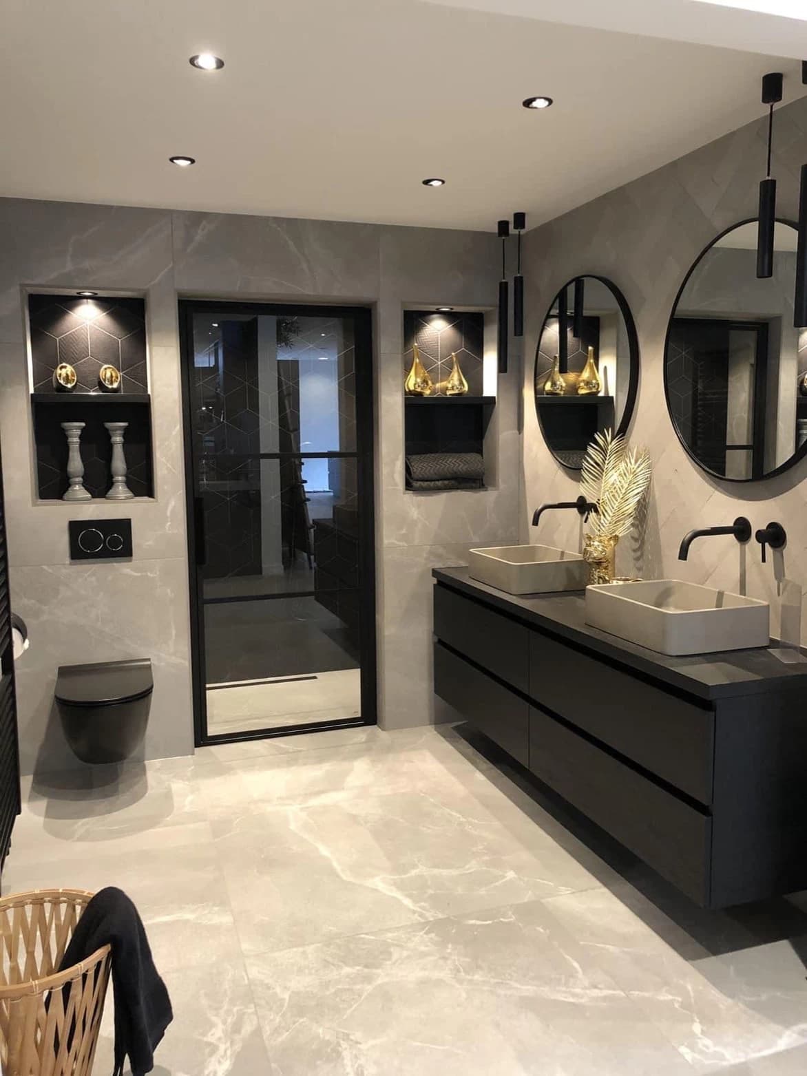 Modern bathroom with double vessel sinks, black floating vanity, and round mirrors